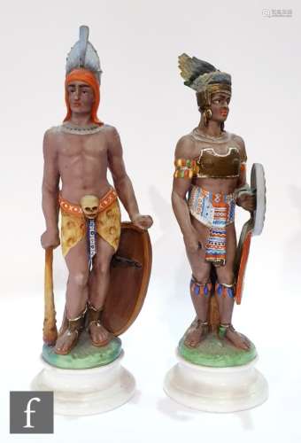 A pair of early 20th Century continental bisque figures, each modelled as native American figures,