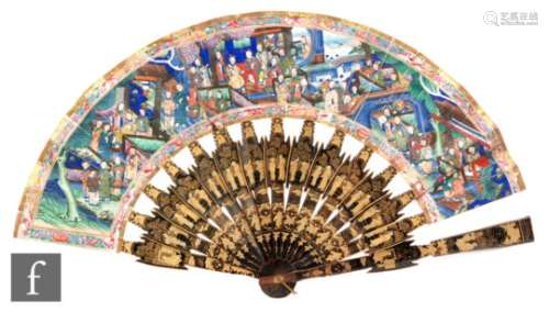 A 19th Century Japanese hand painted folding fan decorated with figures in building and garden