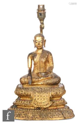 A 19th Century Sino-Tibetan gilt bronze/copper alloy figure of shakyamuni buddha, seated of a tiered