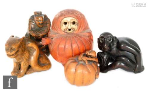 A collection of 19th to 20th Century carved hardwood netsuke to include a Daruma (lacking protruding