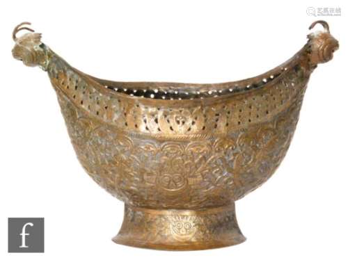 A late 19th to early 20th Century Persian hammered copper Kashkul (beggars bowl), the pierced oval