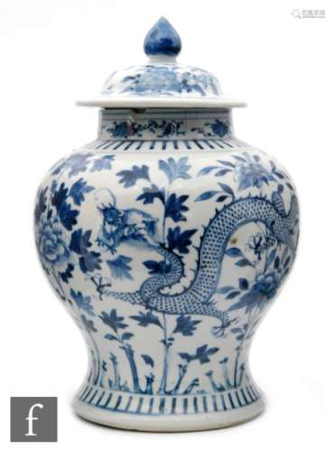 A Chinese blue and white Kangxi style meiping vase with domed cover with pointed finial, decorated