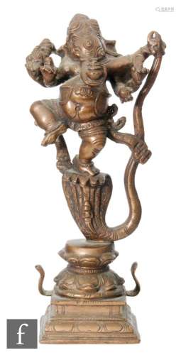A 19th Century Sino-Tibetan copper alloy or bronze shrine of a dancing Ganesha, raised on a double