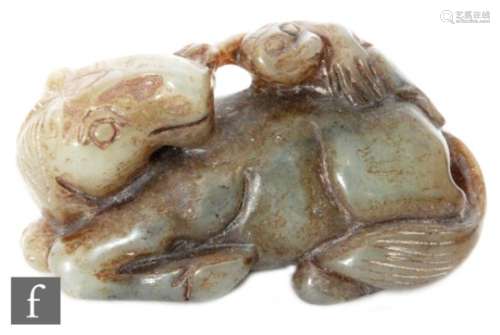 A Chinese 19th Century jade carving, the dark green stone modelled as a recumbent horse with