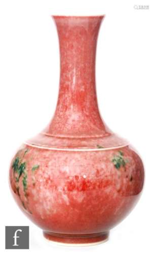 A Chinese Peachbloom vase of bottle form rising to a splayed rim, the pink mottled ground blushing