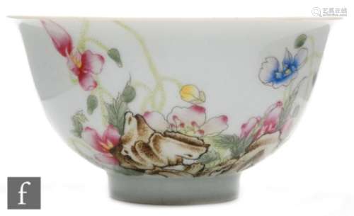 A Chinese famille rose bowl, the high footring rising to the gently sloped sides with all over white