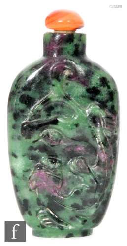 A Chinese 19th Century green hardstone Chilong snuff bottle, of flattened ovoid form, the speckled