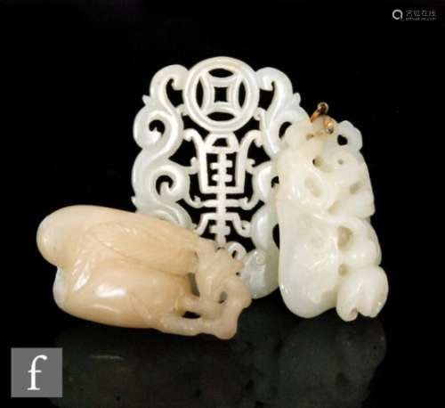 A collection of Chinese green hardstone carvings and pendants, to include a 'double peach'