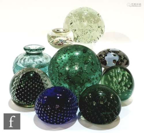 A collection of assorted glass paperweights, mostly globular form with internal controlled air