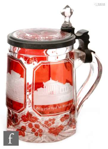 A 19th Century German beer stein cased in ruby and flash cut and engraved with Bavarian landmarks