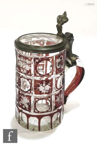 A 19th Century Bohemian beer stein in clear crystal with ruby flash decoration in a panel design