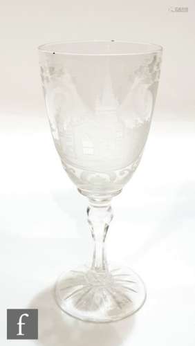A 19th Century clear crystal goblet engraved to the bowl with a view of a church within a border