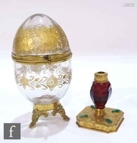 A 19th Century ruby glass facet cut scent bottle with fine engraved gilded mounts, raised to a