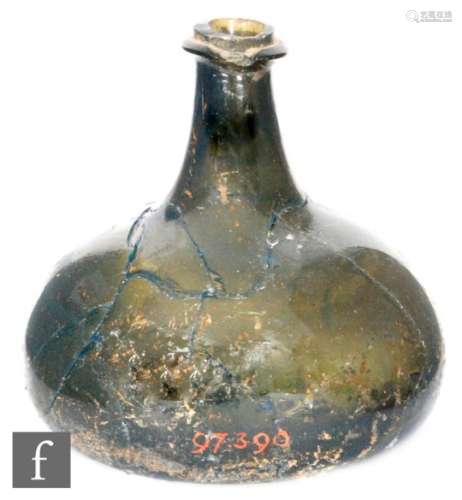 An 18th Century onion form bottle of low shouldered form with drawn neck and bladed rim, smashed and