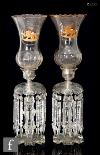 A pair of large 19th Century clear crystal table lustres with a radial cut petal edge foot beneath a