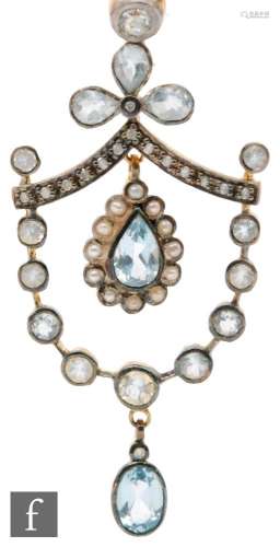 A silver gilt Edwardian style aquamarine and diamond set open work pendant terminating in aquamarine