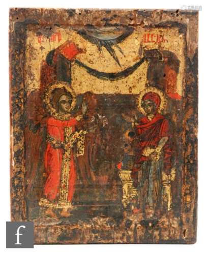 A 17th Century style Russian painted wooden icon of an angelic winged figure offering a sprig of