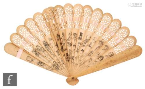 An early 20th Century carved and pierced wooden fan, each stick decorated with sketches of Dickens