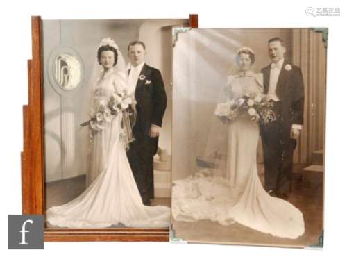 A pair of 1930s Art Deco colour tinted photographs in oak frames of a bride and groom on their