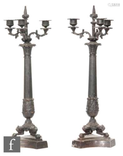 A pair of 20th Century French empire bronze candlesticks, each with triple sconces on reeded columns