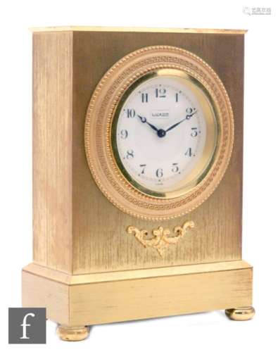 A 20th Century gilt mantle clock by Luxor in the Empire style on a stepped base and ball feet,