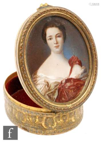 A late 19th and early 20th Century French gilt oval box painted with a portrait of a lady wearing