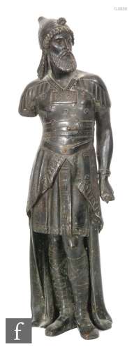 A 19th Century bronze figure of a Persian warrior in military dress holding a scroll, lacking