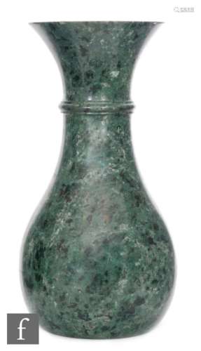 A 20th Century mottled black and green hardstone flared lip vase of baluster form, height 28cm.