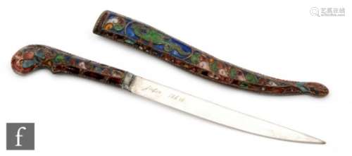 A mid 20th Century champleve enamelled paper knife in the form of a dagger and scabbard decorated