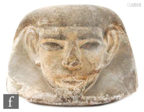 An Egyptian human-headed large limestone canopic jar lid with traces of paint, height 13cm, diameter