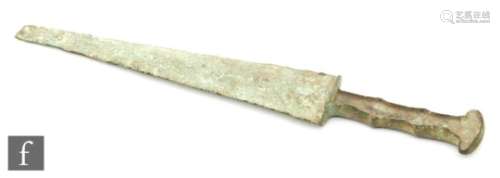 A classic Luristan bronze dagger, circa 1000 BC, the grip recessed for wooden or bone insets, length
