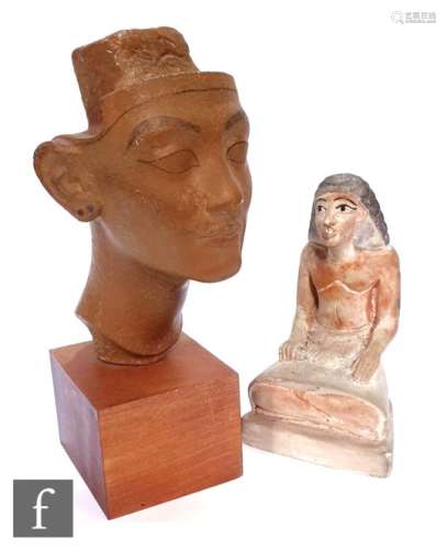 A museum facsimile of the ?unfinished head of Queen Nefertiti? mounted on a wooden base and a