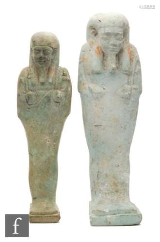An Egyptian faience baboon amulet and four shabti figures, largest 14.5cm. (5)