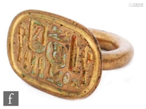 An Egyptian revival bronze seal ring with hieroglyphic cartouche.