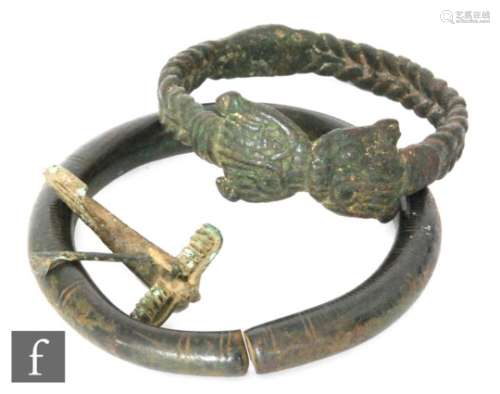 A Roman bronze crossbow brooch, circa 1st to 2nd century, a heavy bronze Hallstatt type bracelet