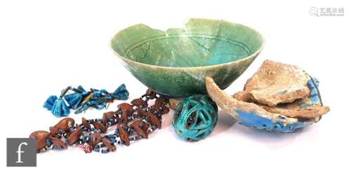 A Kashan incised pottery bowl, S/D, a reticulated Persian pottery ?egg?, a string of faience