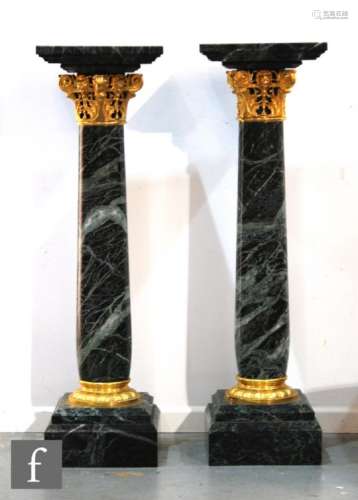 A pair of 20th Century green serpentine stone and part gilt mounted torcheres in the classical