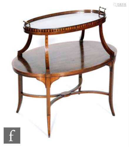 An early 20th Century mahogany two-tier etagere of oval form, with rosewood and satinwood line