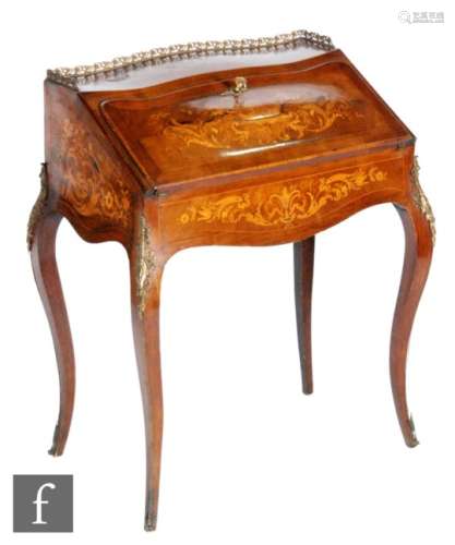 A late 19th Century French marquetry inlaid bureau, the fitted interior above a slide enclosed by