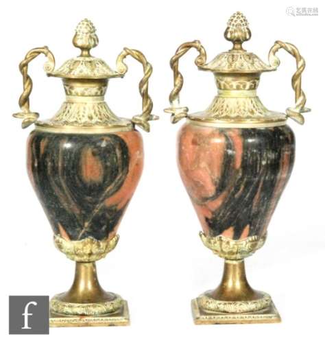 A pair of decorative brass mounted marble urn-shaped pedestal garnitures of ovoid form, with twin