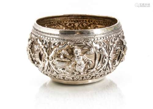 An early 20th century Indian silver bowl, circular Burmese style with ornate embossed figures and