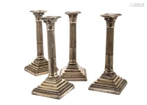 A set of four George V silver filled candlesticks by HE Ltd, AF, each Corinthian style fluted column