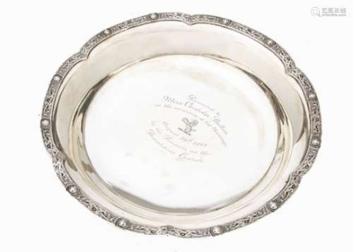 An Art Deco period silver presentation dish by W&W, having shaped rim with Celtic band, well with