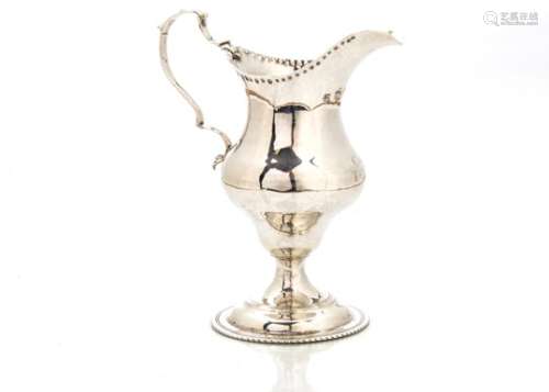 A George III silver cream jug by CH, London 1787, helmet shaped on socle base, possibly repaired