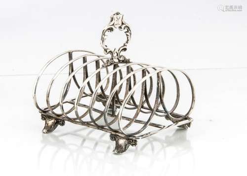 An early Victorian silver toast rack by G.I, with six spaces, handle with engraved family crest,