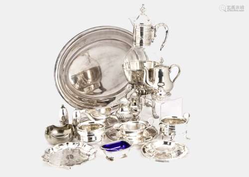 A collection of silver plated tableware items, including a glass jug on warmer stand, an oval