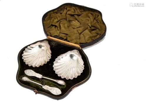 A pair of Victorian silver shell shaped butter dishes from Mappin & Webb, with a pair of silver