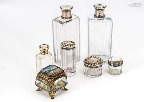 A pair of early 20th century French cut glass and silver capped dressing table bottles, together