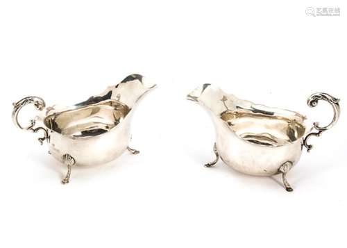 A pair of George V silver sauce boats from SB & S Ltd, scalloped rims, C scroll handles on three