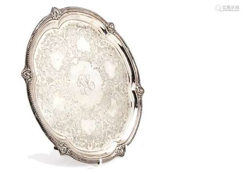 An Edwardian silver salver by HA, circular with shaped rim, engraved well with initials to centre,